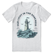 Christian t-shirt with the phrase “Light in the Darkness” in bold typography; unisex faith tee symbolizing hope, truth, and God’s presence in dark times.
