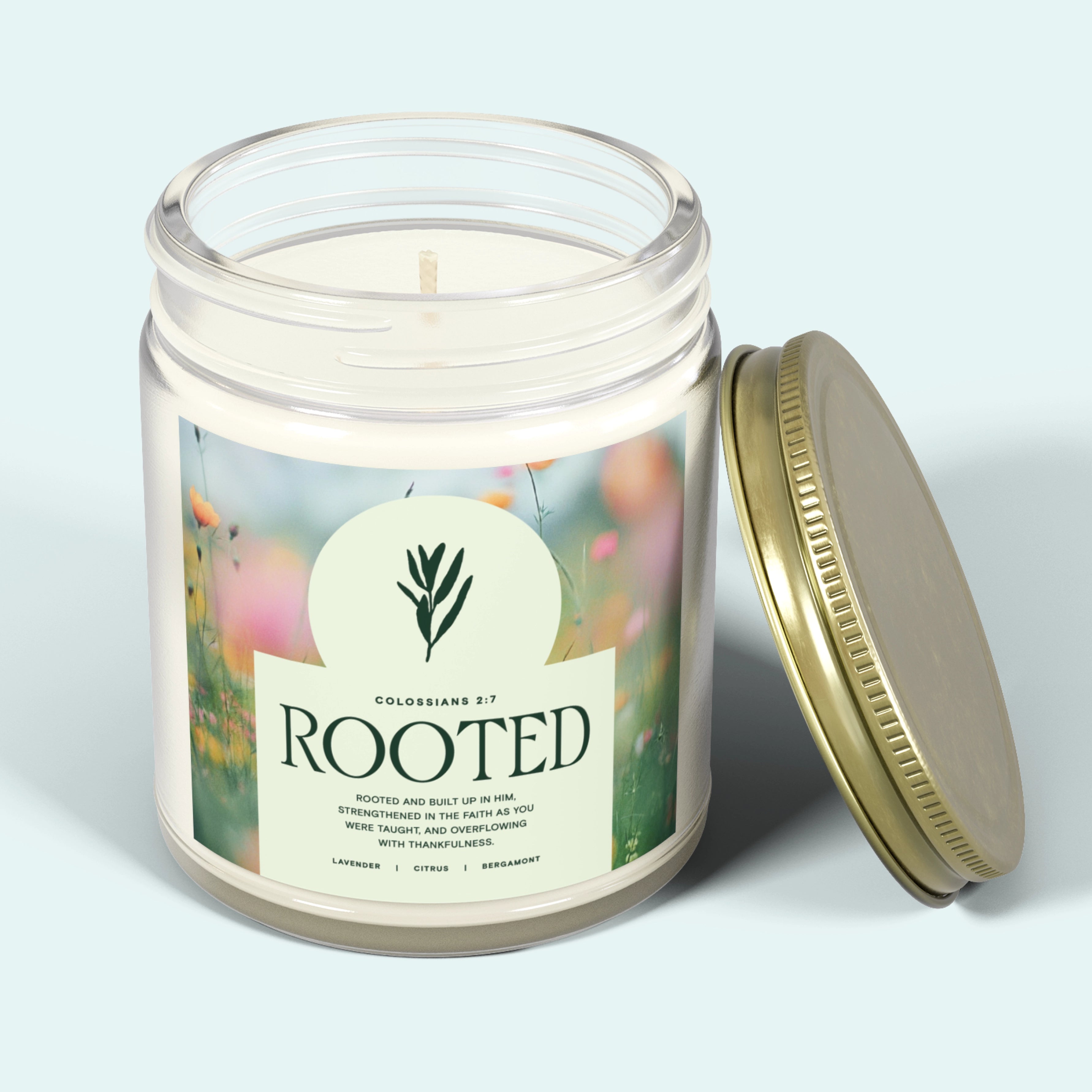 White jar candle labeled “Rooted” with a gold lid, featuring a calming lavender scent. A Christian gift symbolizing faith grounded in God’s love and peace.