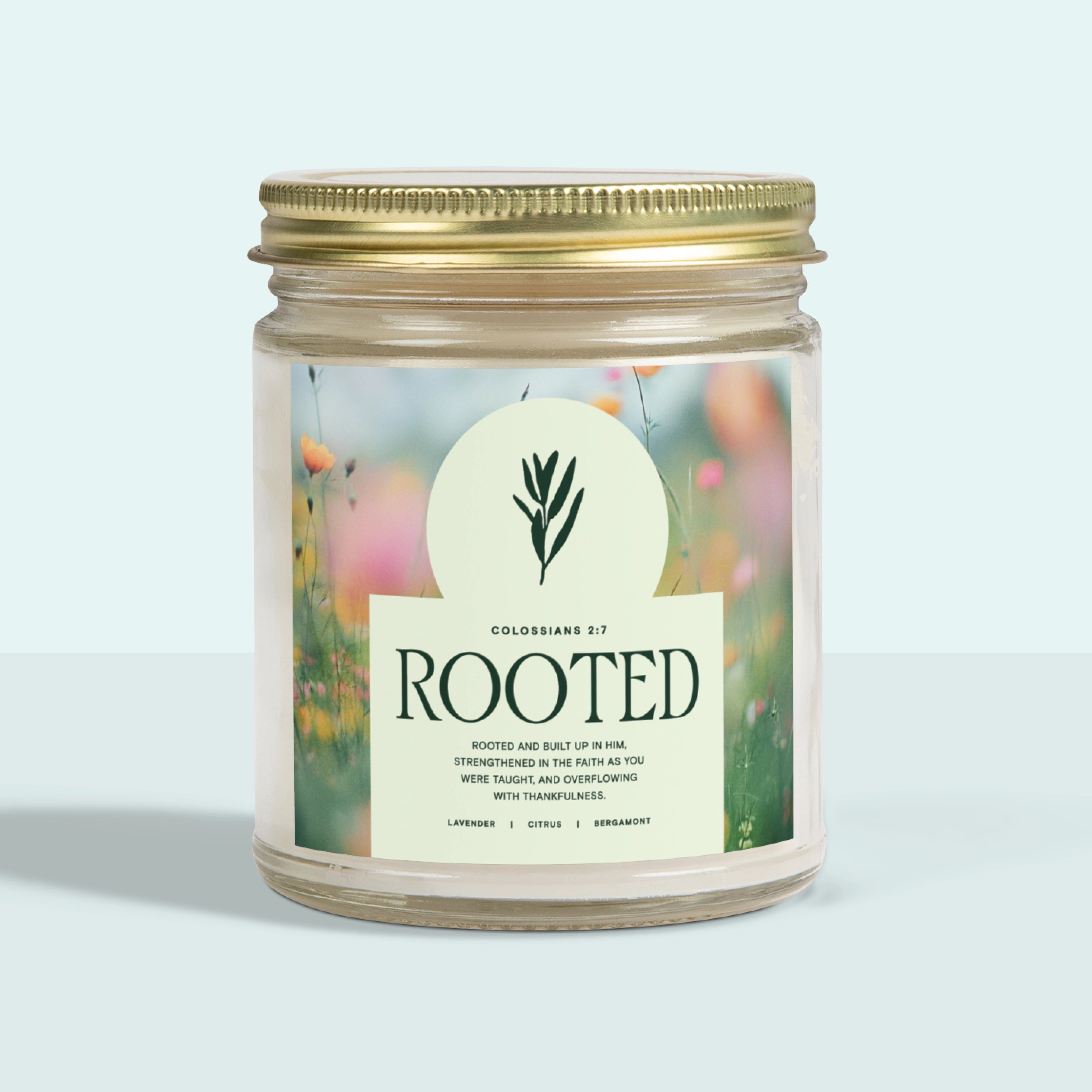 White jar candle labeled “Rooted” with a gold lid, featuring a calming lavender scent. A Christian gift symbolizing faith grounded in God’s love and peace.