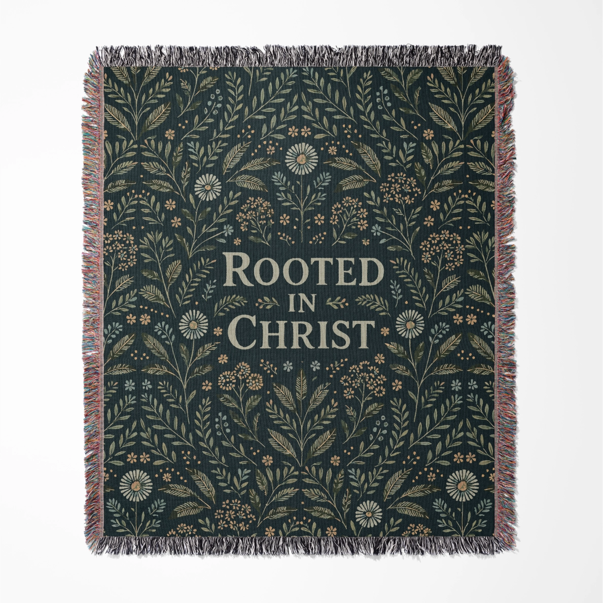 Faith-inspired woven blanket with floral patterns and the phrase “Rooted in Christ,” made from soft cotton—Christian home decor and gift.