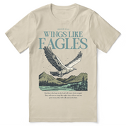 Christian t-shirt with the phrase “Wings Like Eagles” and an eagle illustration, inspired by Isaiah 40:31; unisex faith tee representing strength, renewal, and trust in God.