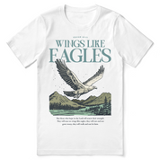 Christian t-shirt with the phrase “Wings Like Eagles” and an eagle illustration, inspired by Isaiah 40:31; unisex faith tee representing strength, renewal, and trust in God.