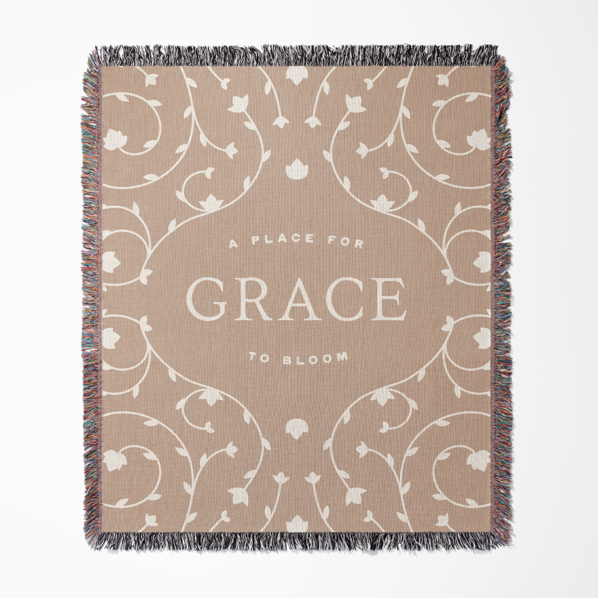 Blanket with 'A Place for Grace to Bloom' text and floral patterns on a beige background