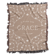 Beige blanket with floral patterns and 'A Place for Grace to Bloom' text