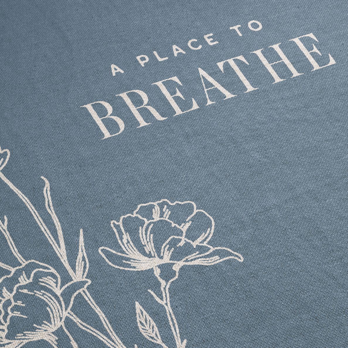 Text 'A Place to Breathe' with floral illustrations on a blue background