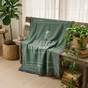 Green blanket with text in a room with plants and wooden furniture