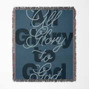 Blanket with 'All Glory to God' text on a blue background