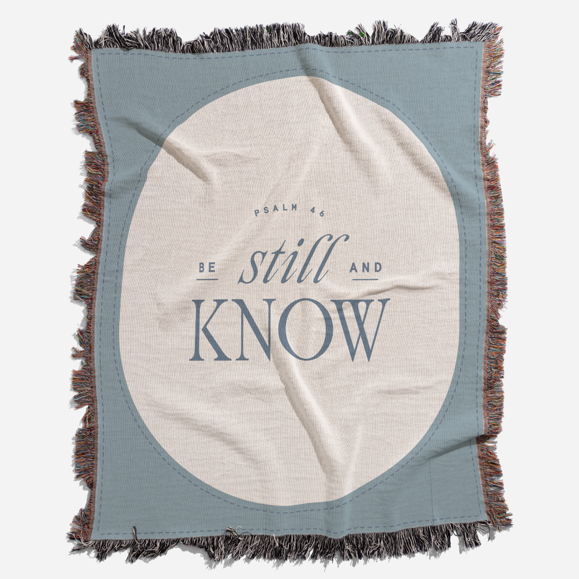 Blanket with 'Be still and know' text on a white background