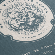 Floral design with text 'Be Still and Know That I Am God' on a blue background