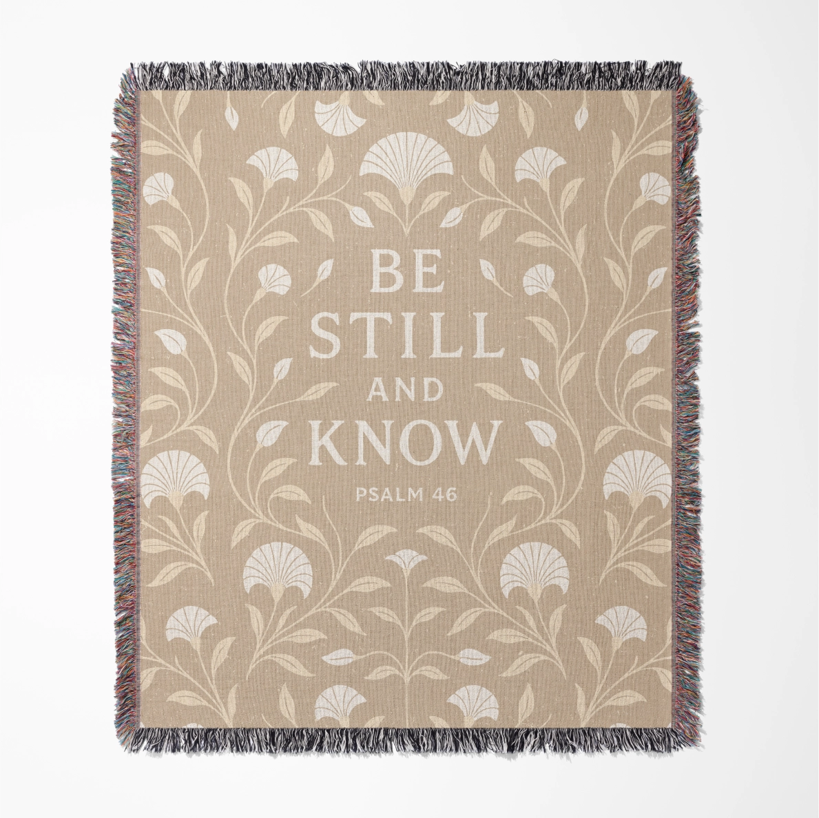 Cream-colored woven blanket with the phrase “Be still and know” from Psalm 46, made of 100% cotton with fringe; a peaceful Christian gift for nurseries or weddings.