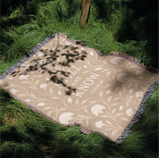 Cream-colored woven blanket with the phrase “Be still and know” from Psalm 46, made of 100% cotton with fringe; a peaceful Christian gift for nurseries or weddings.