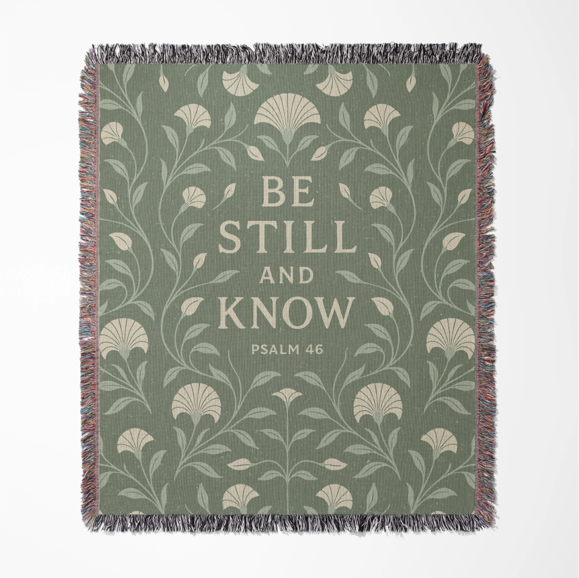 Soft green woven blanket with the phrase “Be still and know” from Psalm 46, 100% cotton with fringe; a peaceful Christian gift for weddings, nurseries, or devotion spaces.