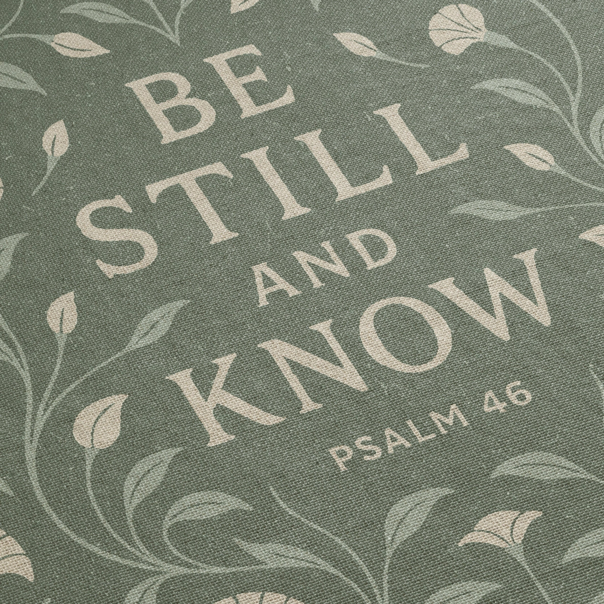 Soft green woven blanket with the phrase “Be still and know” from Psalm 46, 100% cotton with fringe; a peaceful Christian gift for weddings, nurseries, or devotion spaces.