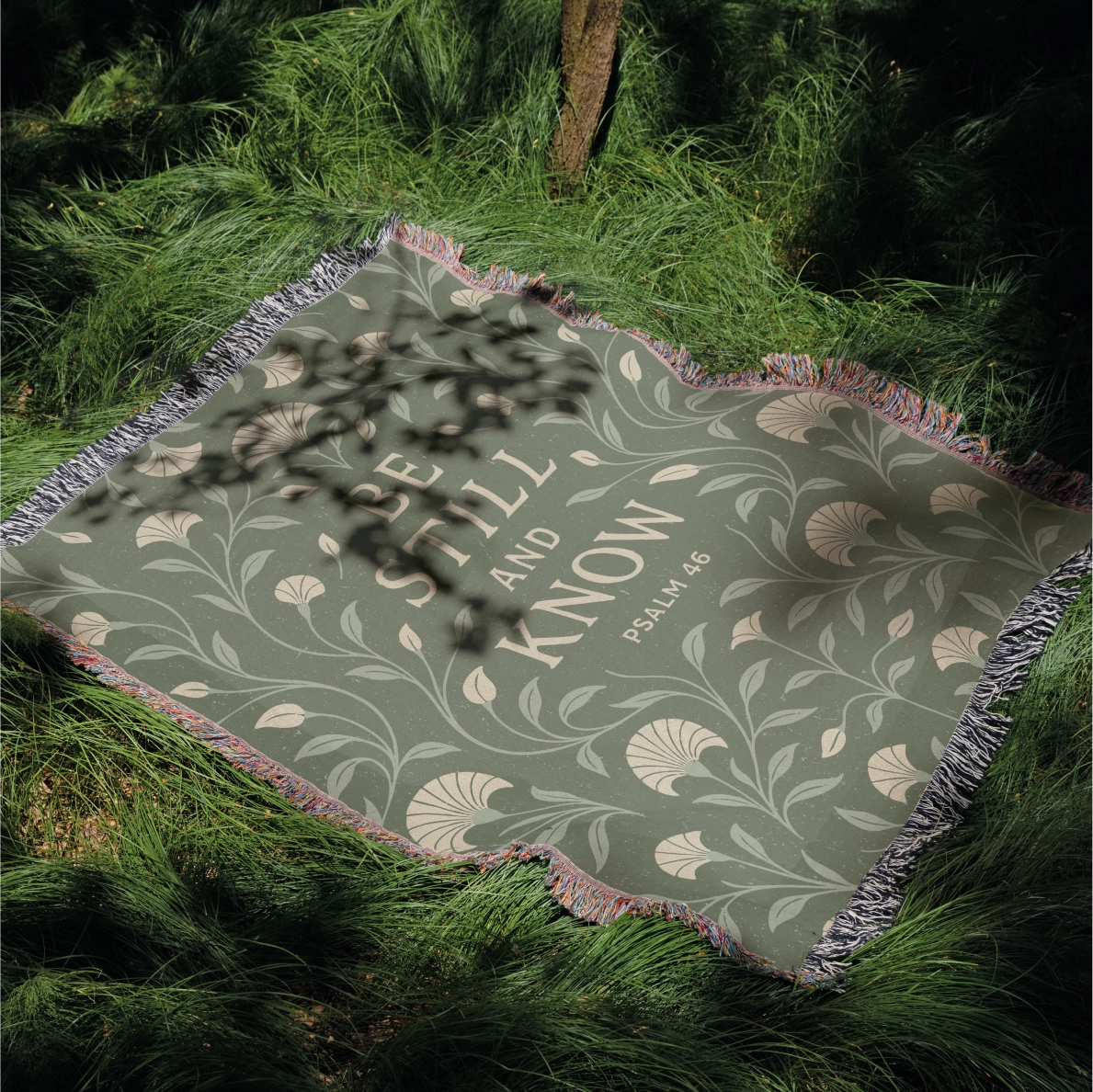 Soft green woven blanket with the phrase “Be still and know” from Psalm 46, 100% cotton with fringe; a peaceful Christian gift for weddings, nurseries, or devotion spaces.