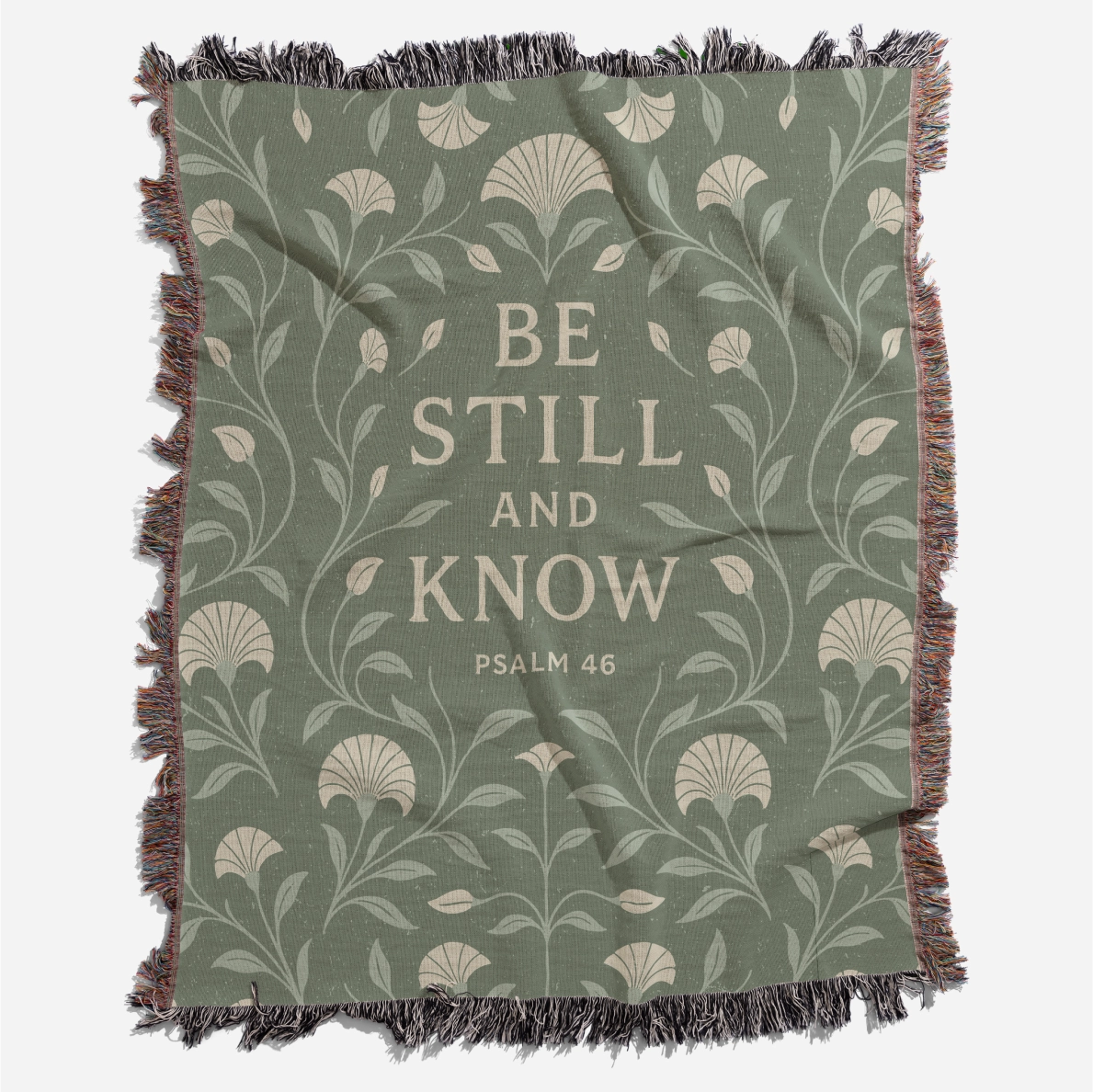 Soft green woven blanket with the phrase “Be still and know” from Psalm 46, 100% cotton with fringe; a peaceful Christian gift for weddings, nurseries, or devotion spaces.