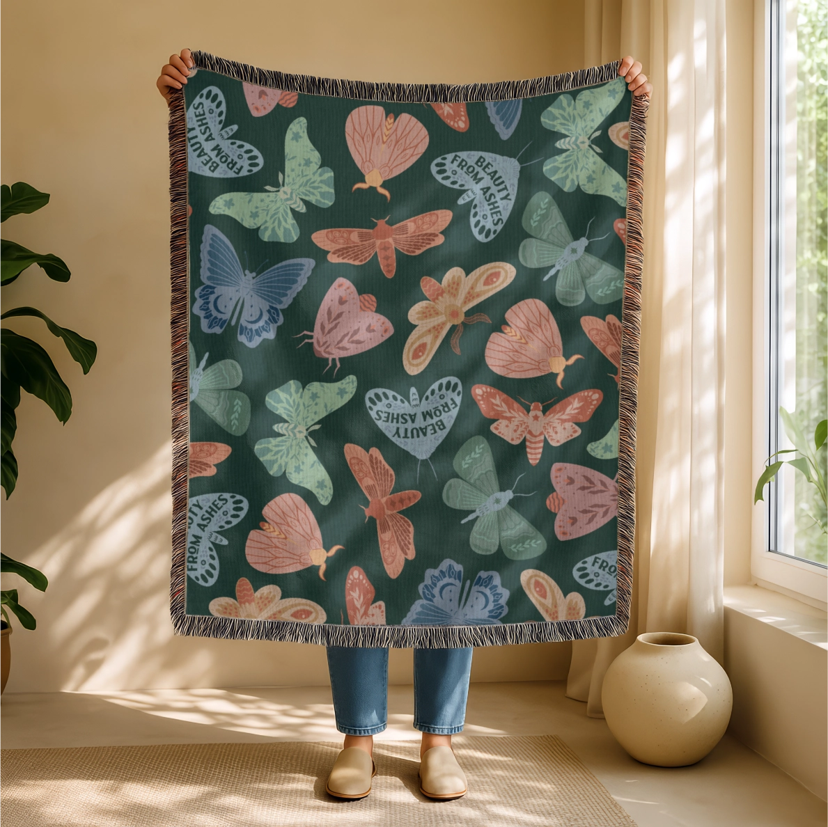 Faith-inspired woven blanket with hand-drawn butterflies and moths on a deep background, made from 100% cotton with colorful fringed edges—Christian home decor.