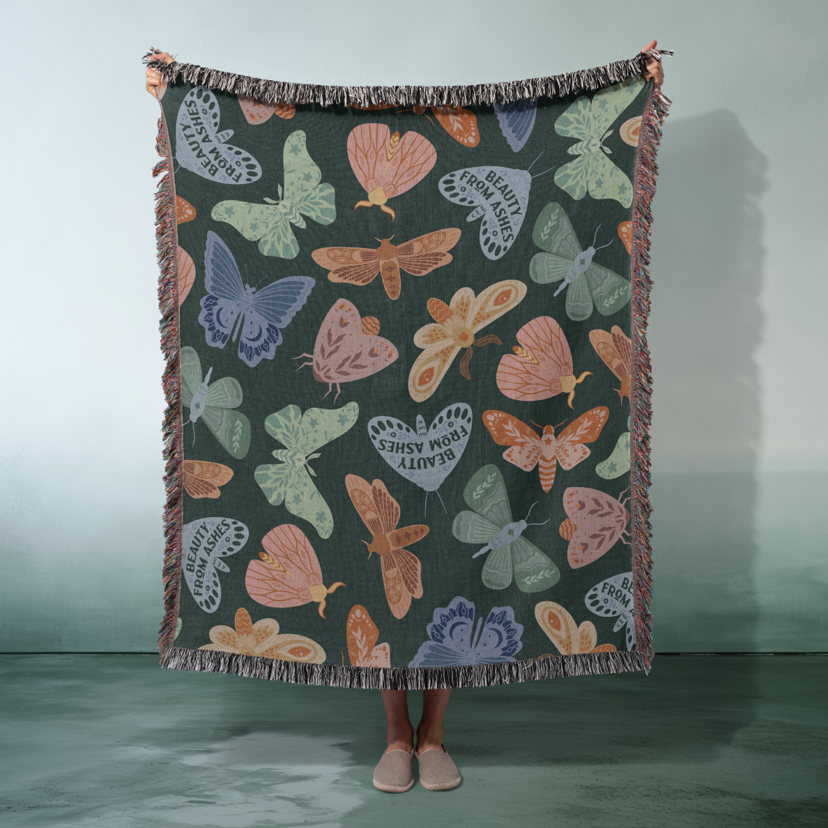 Butterfly patterned blanket draped over a person against a plain background