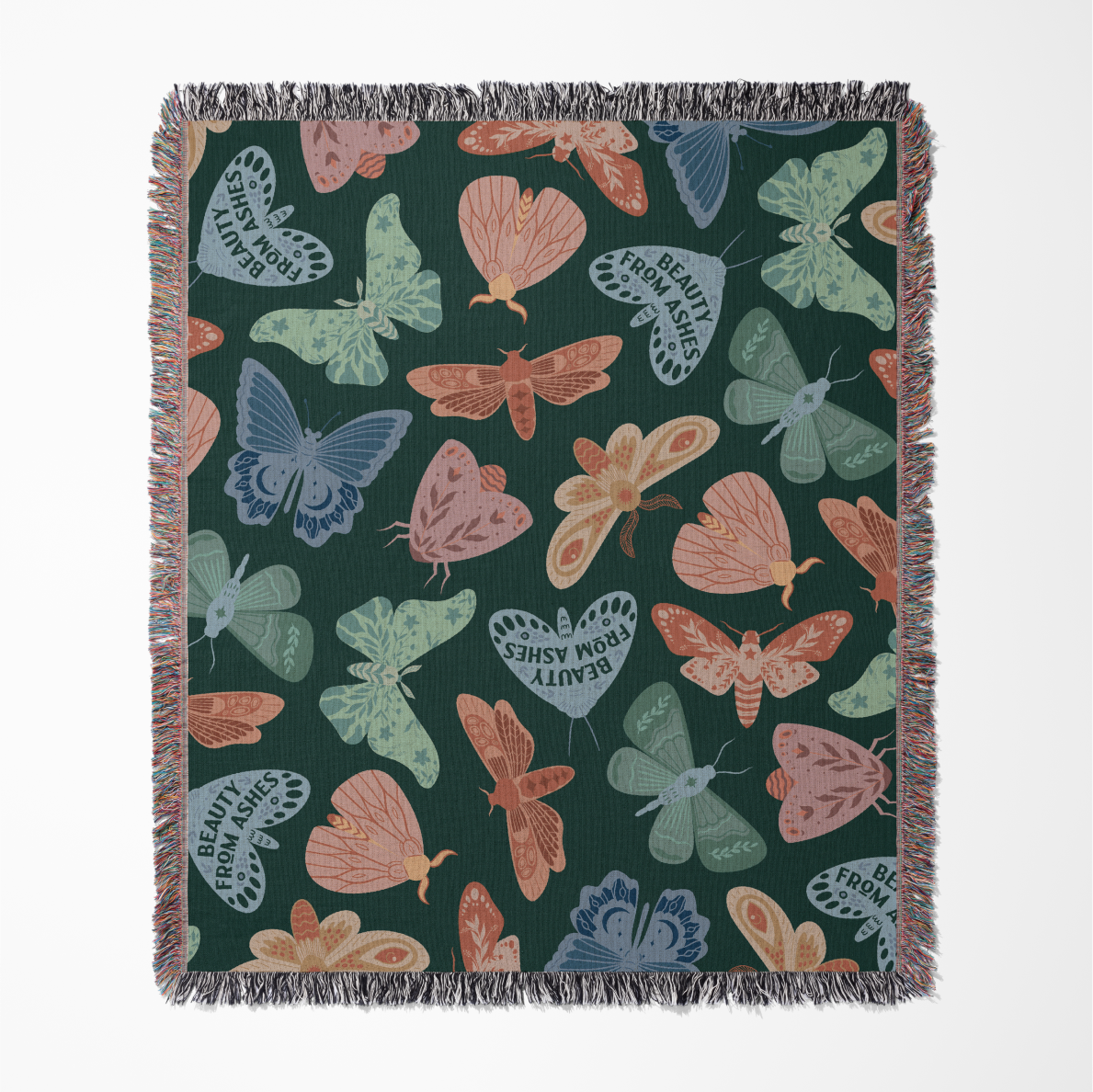 Faith-inspired woven blanket with hand-drawn butterflies and moths on a deep background, made from 100% cotton with colorful fringed edges—Christian home decor.