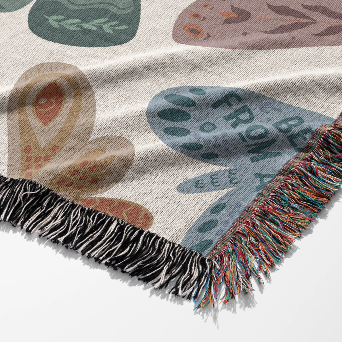 Faith-inspired woven blanket with hand-drawn butterflies and moths on a soft light background, made from 100% cotton with colorful fringed edges—Christian home decor.