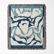 Floral patterned throw blanket with text on a white background