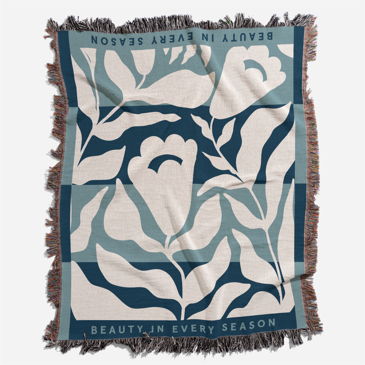 Floral patterned blanket with text 'Beauty in Every Season' on a white background