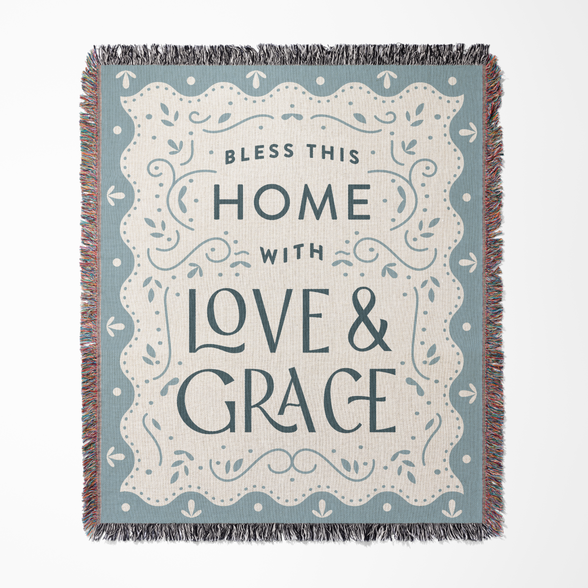 Blanket with 'Bless this home with love & grace' text on a blue background