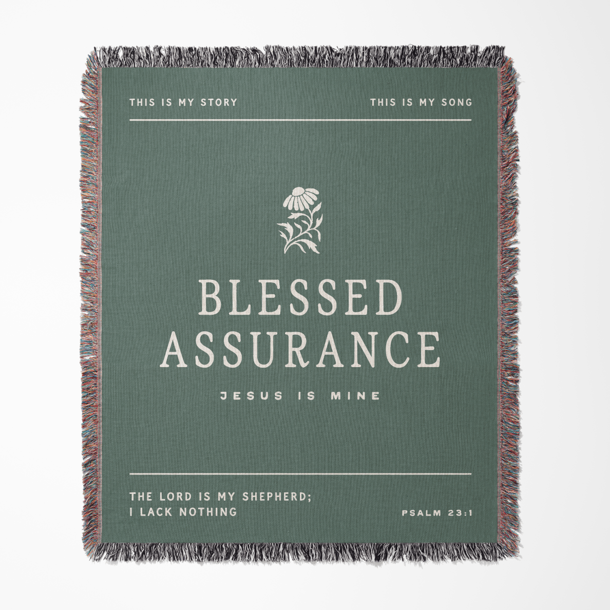 A square woven throw blanket with fringed edges, featuring a sage green background and white text that reads 'BLESSED ASSURANCE' with smaller scripture text around it. The design is centered on a light gray background.