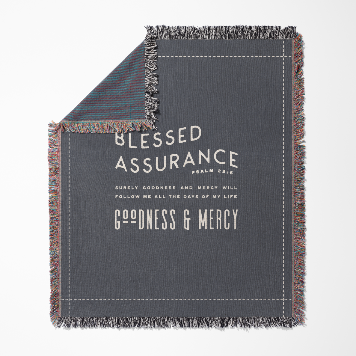 Gray blanket with text 'Blessed Assurance' and 'Goodness & Mercy' on a white background
