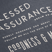 Text on a fabric with 'Blessed Assurance' and Psalm 23:6 quote.