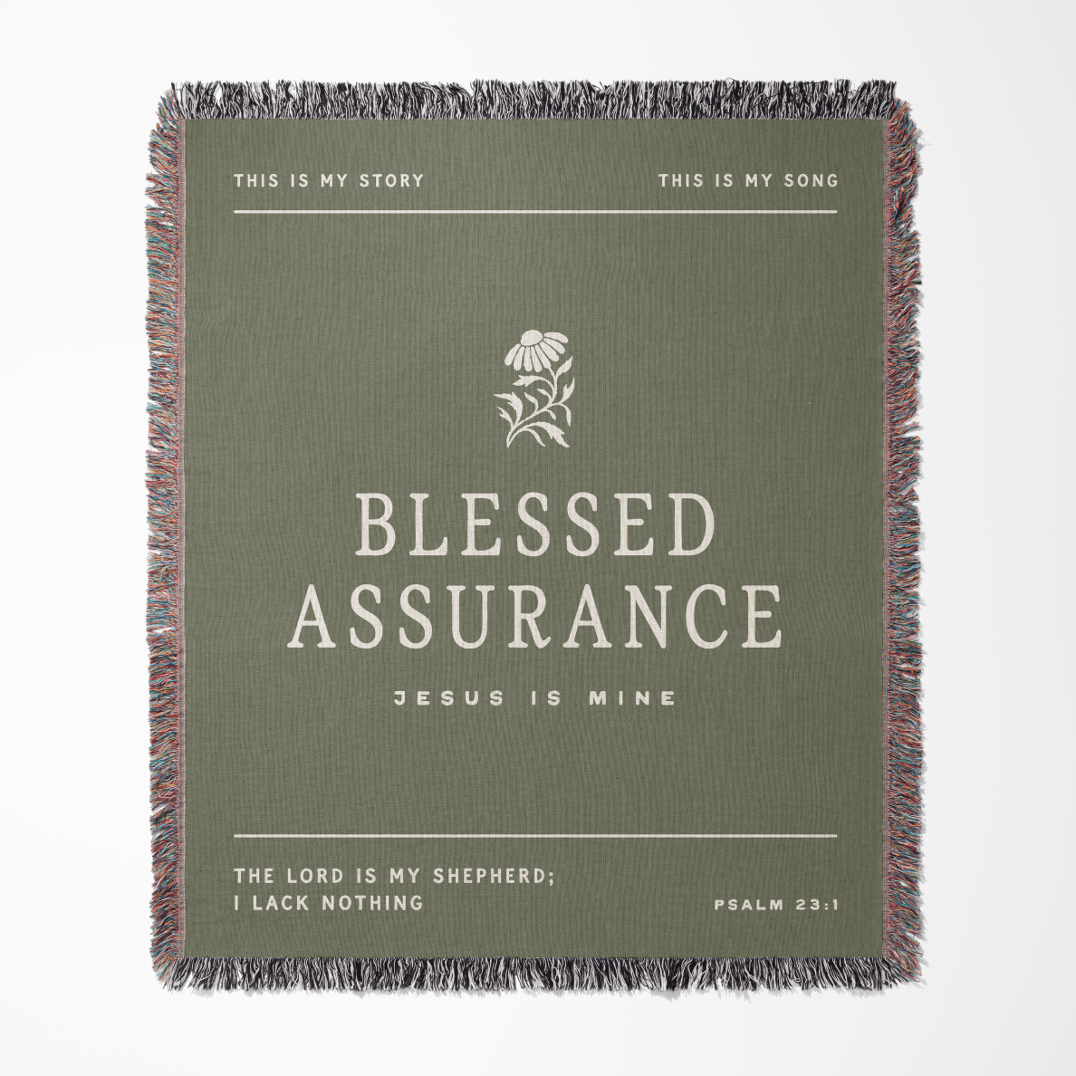 Green blanket with text and floral design, featuring the phrase 'Blessed Assurance'.