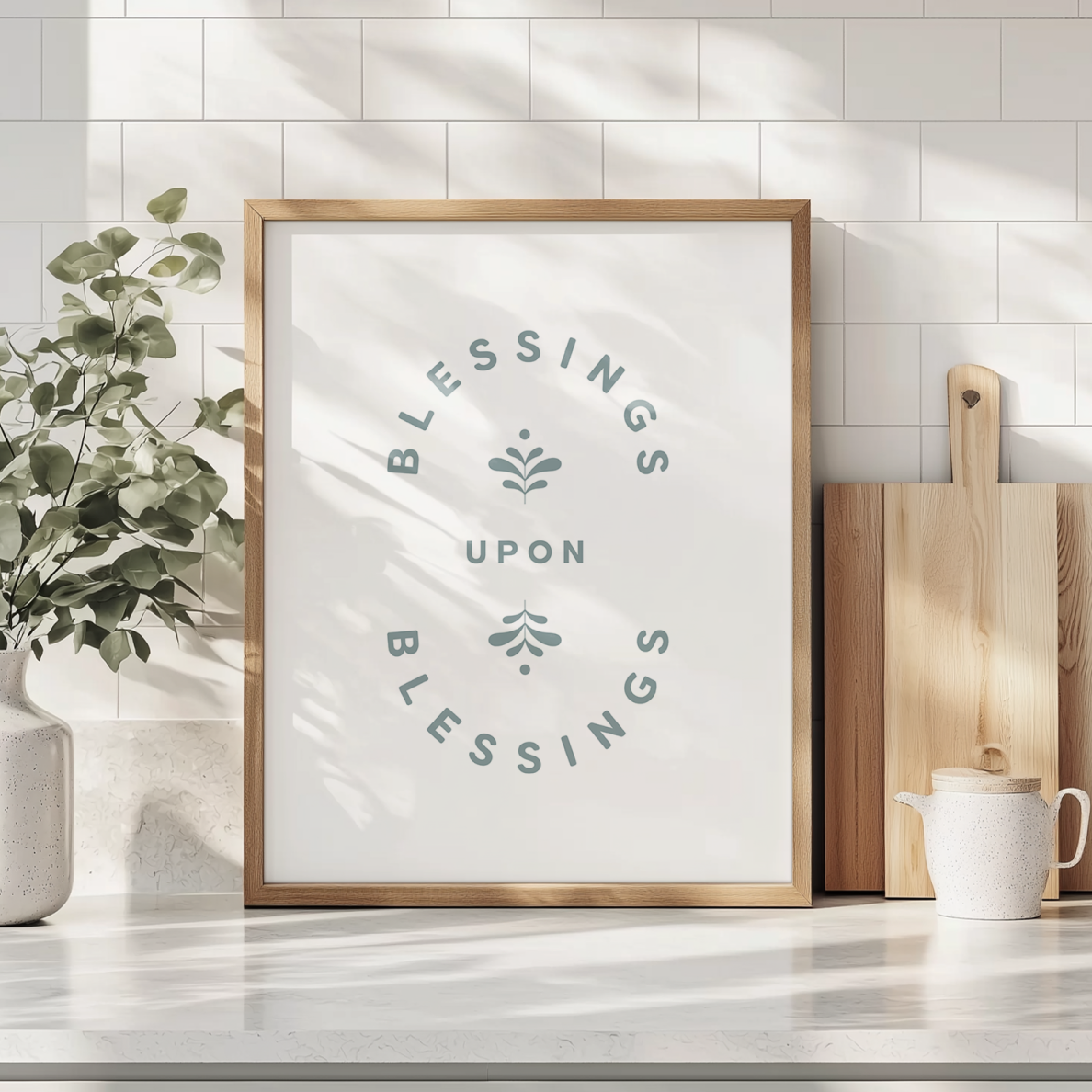Framed artwork with 'Blessings Upon Blessings' text in a kitchen setting.