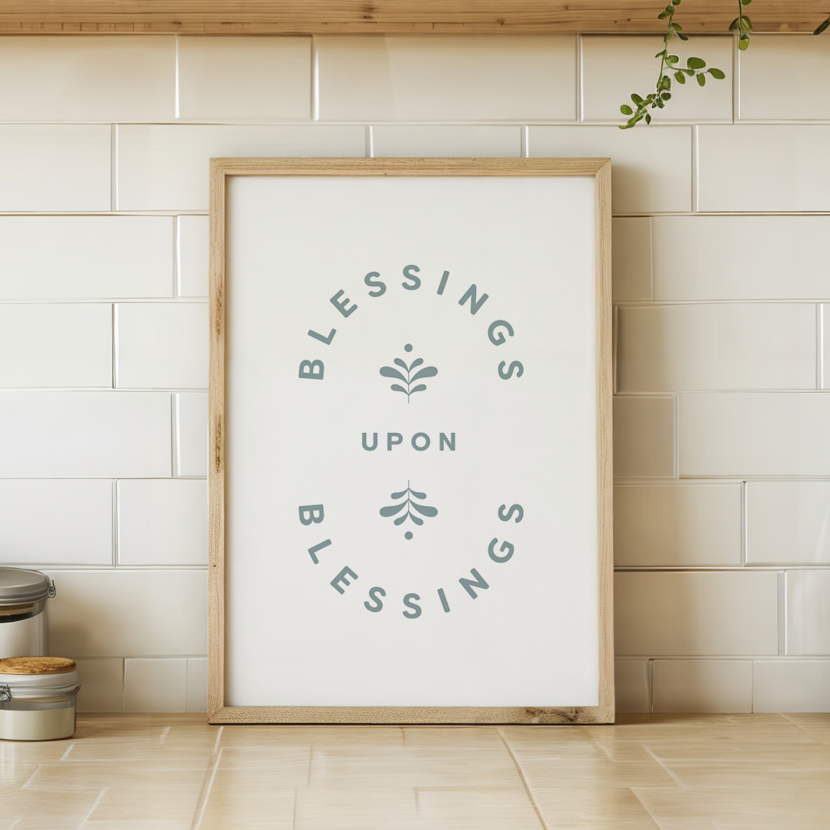 Framed artwork with 'Blessings Upon Blessings' text on a tiled wall.