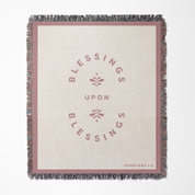 Blanket with 'Blessings Upon Blessings' text and floral design on a white background