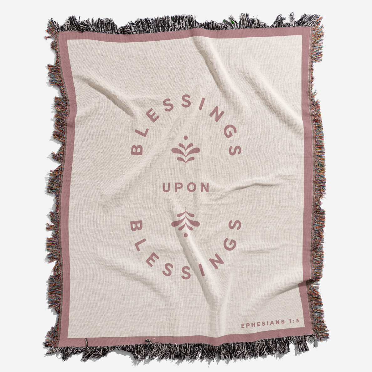 Blanket with 'Blessings Upon Blessings' text and fringes on a white background
