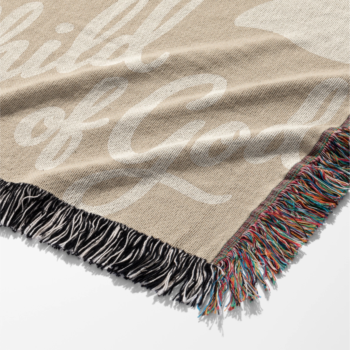 Neutral-toned woven blanket with “Child of God” text and delicate cream foliage design; 100% cotton with fringe, perfect for nurseries, baby gifts, or faith-inspired décor.