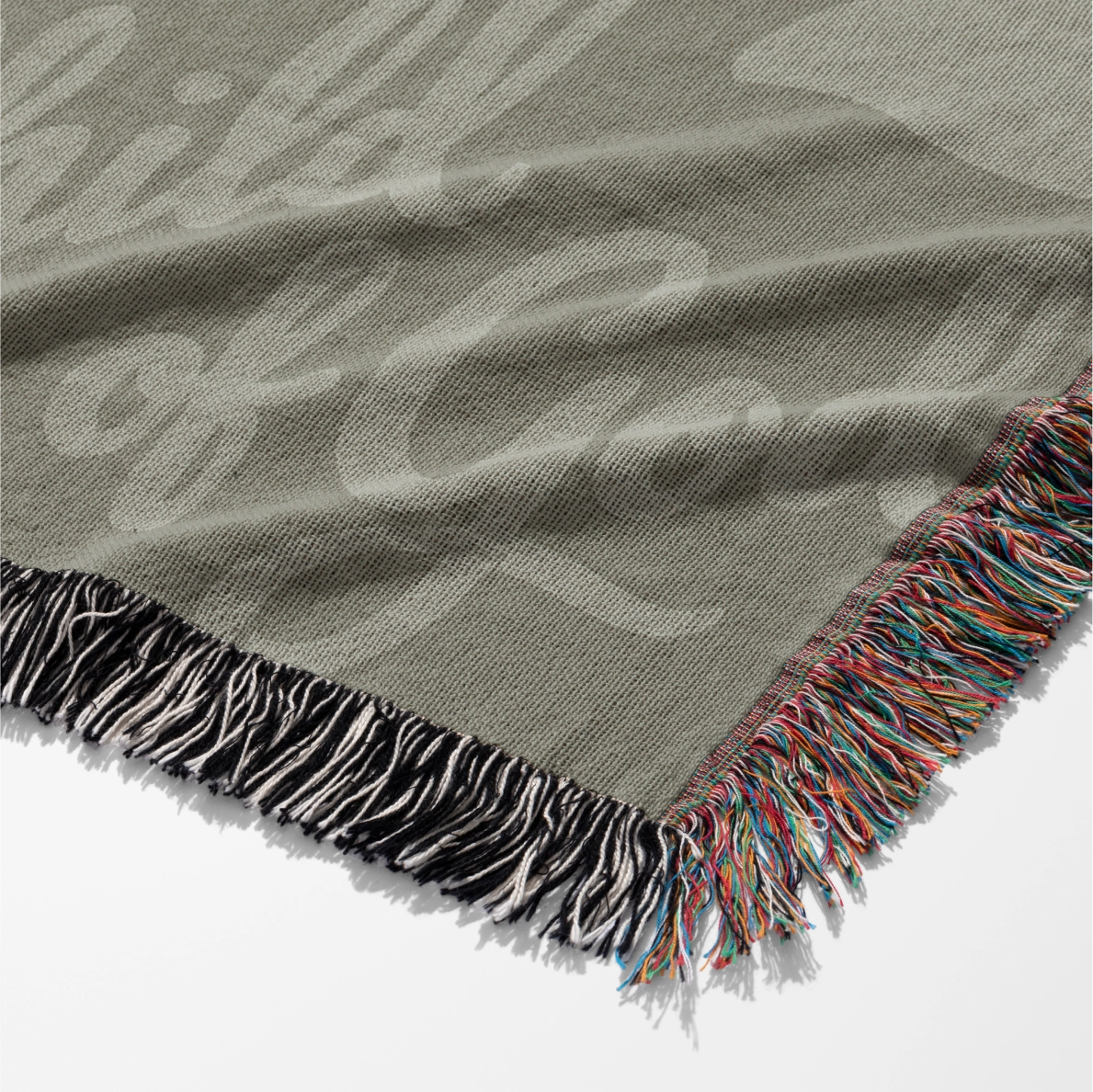 Green earthy-toned woven blanket with foliage pattern and “Child of God” text; made of 100% cotton with fringe, ideal for nurseries, kids’ rooms, or Christian gifts.