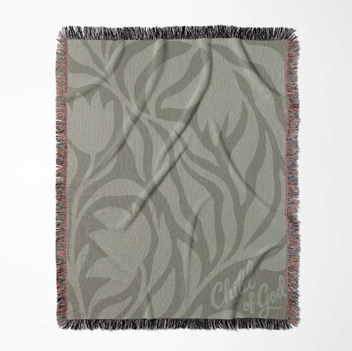 Green earthy-toned woven blanket with foliage pattern and “Child of God” text; made of 100% cotton with fringe, ideal for nurseries, kids’ rooms, or Christian gifts.