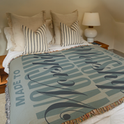 Made to Worship blanket styled on bed.