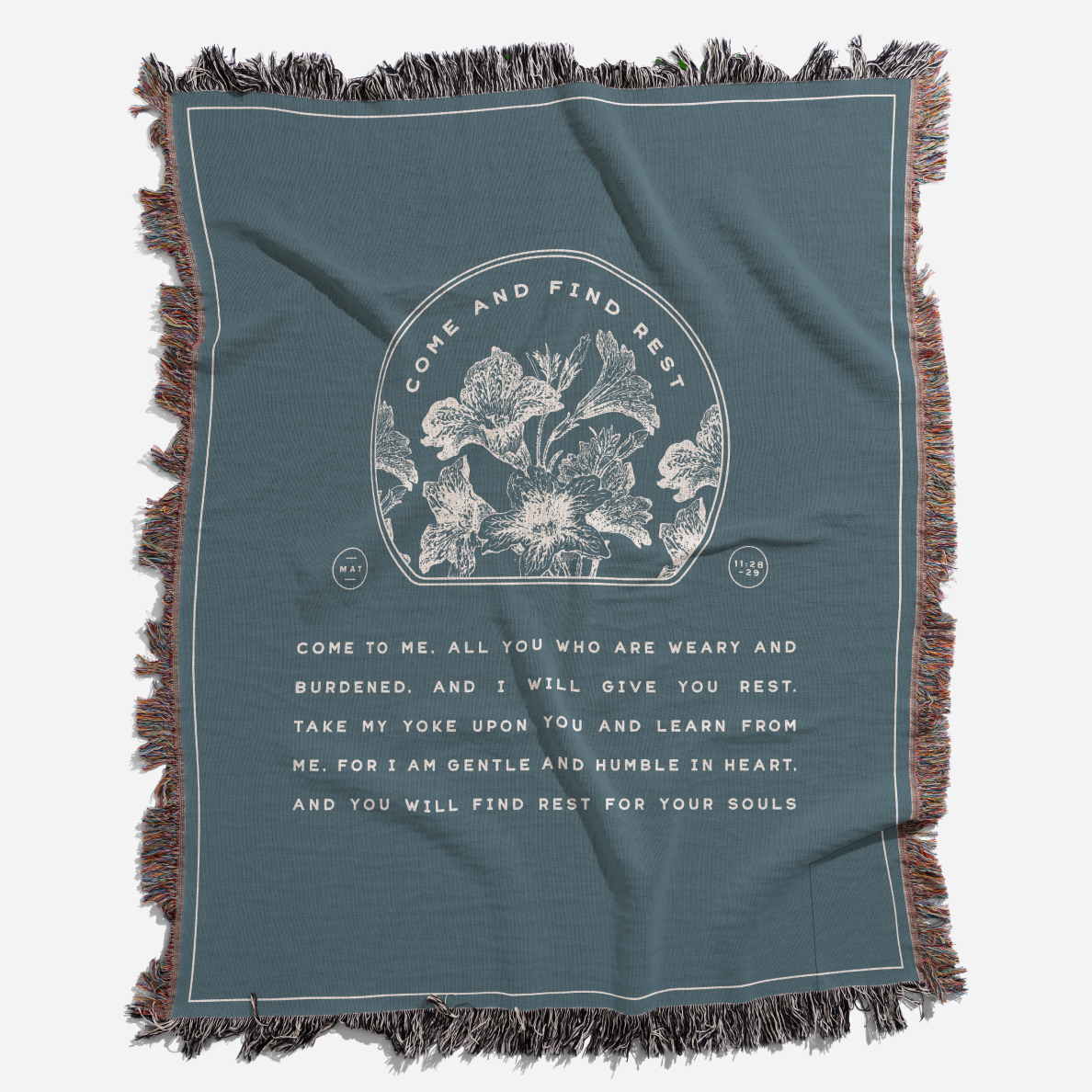 Teal blanket with floral design and text on a white background