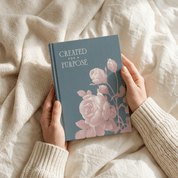 Woman's hands holding open Created for a Purpose christian faith journal showing cover