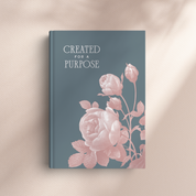 Book with floral design and 'Created for a Purpose' text on a beige background