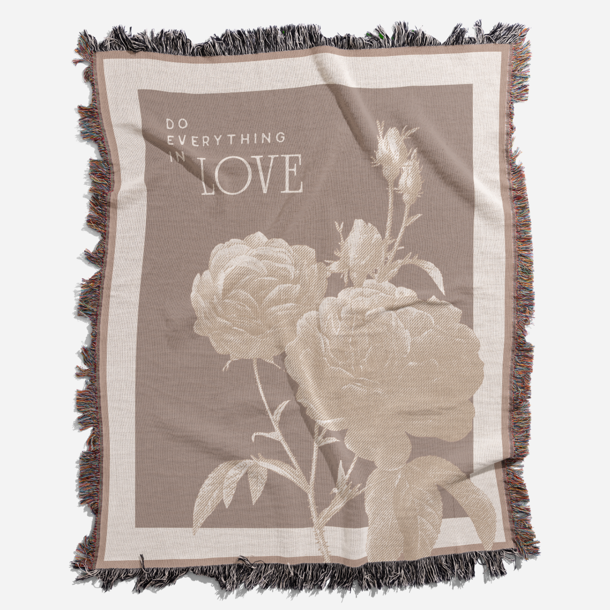 Blanket with floral design and 'Do Everything with Love' text on a white background