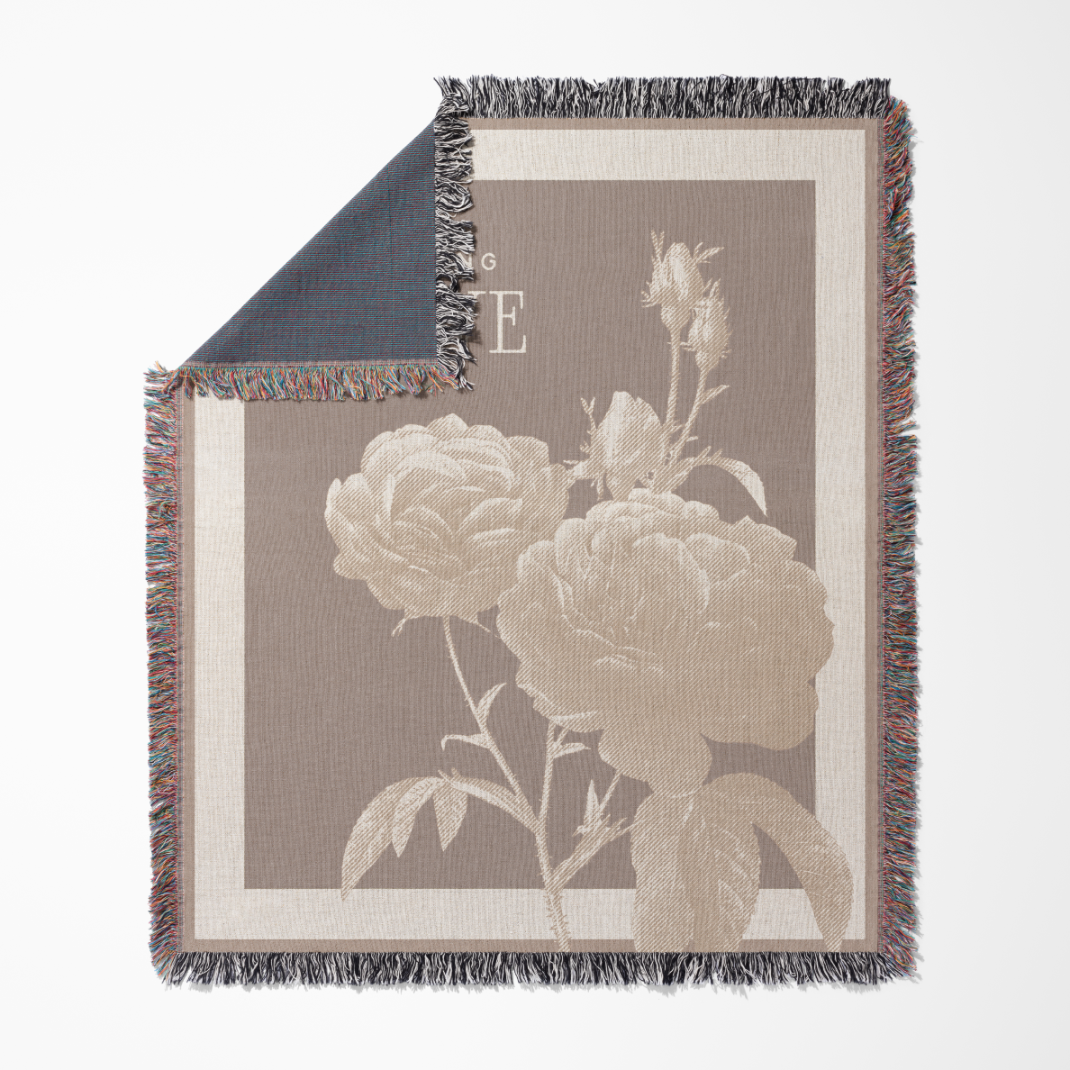 Floral patterned throw blanket with fringe on a white background