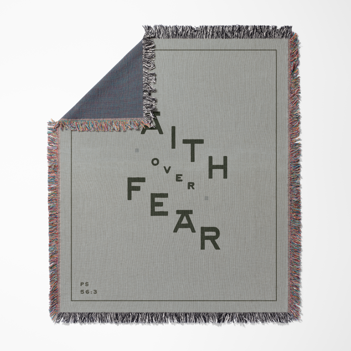 Blanket with 'Faith Over Fear' text on a gray background