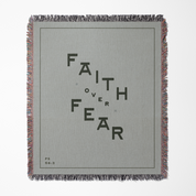 Gray blanket with 'Faith Over Fear' text on a white background