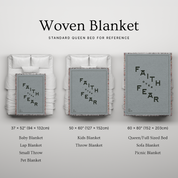 Woven blanket with 'Faith Over Fear' text displayed on a gray background