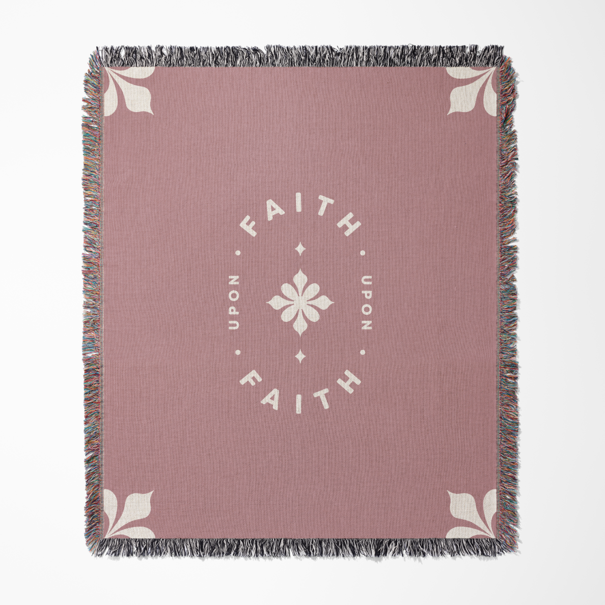 Pink throw blanket with 'Faith Upon Faith' text and floral design on a white background