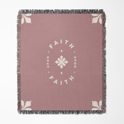 Pink throw blanket with 'Faith Upon Faith' text and floral design on a white background