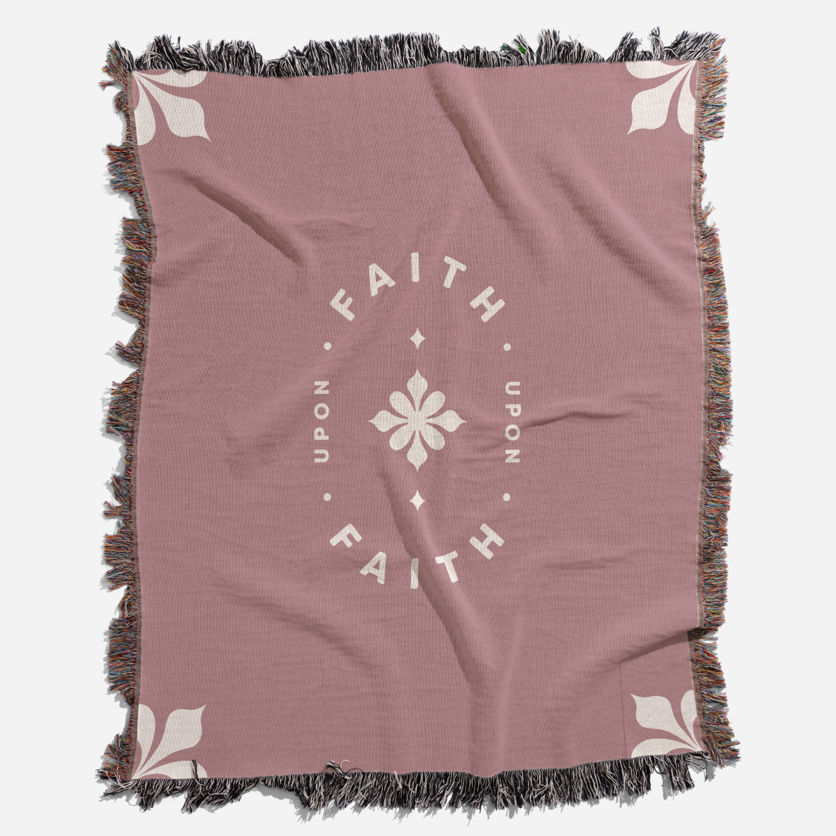 Pink throw blanket with 'Faith Upon Faith' text and floral design on a white background