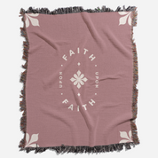 Pink throw blanket with 'Faith Upon Faith' text and floral design on a white background